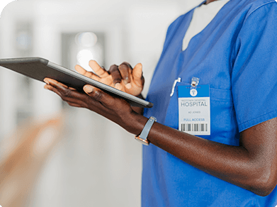 Healthcare Provider in Blue Scrubs holding a clipboard